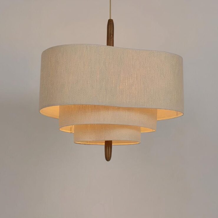 Lustre japonais en tissu beige allumé, sur un fond gris